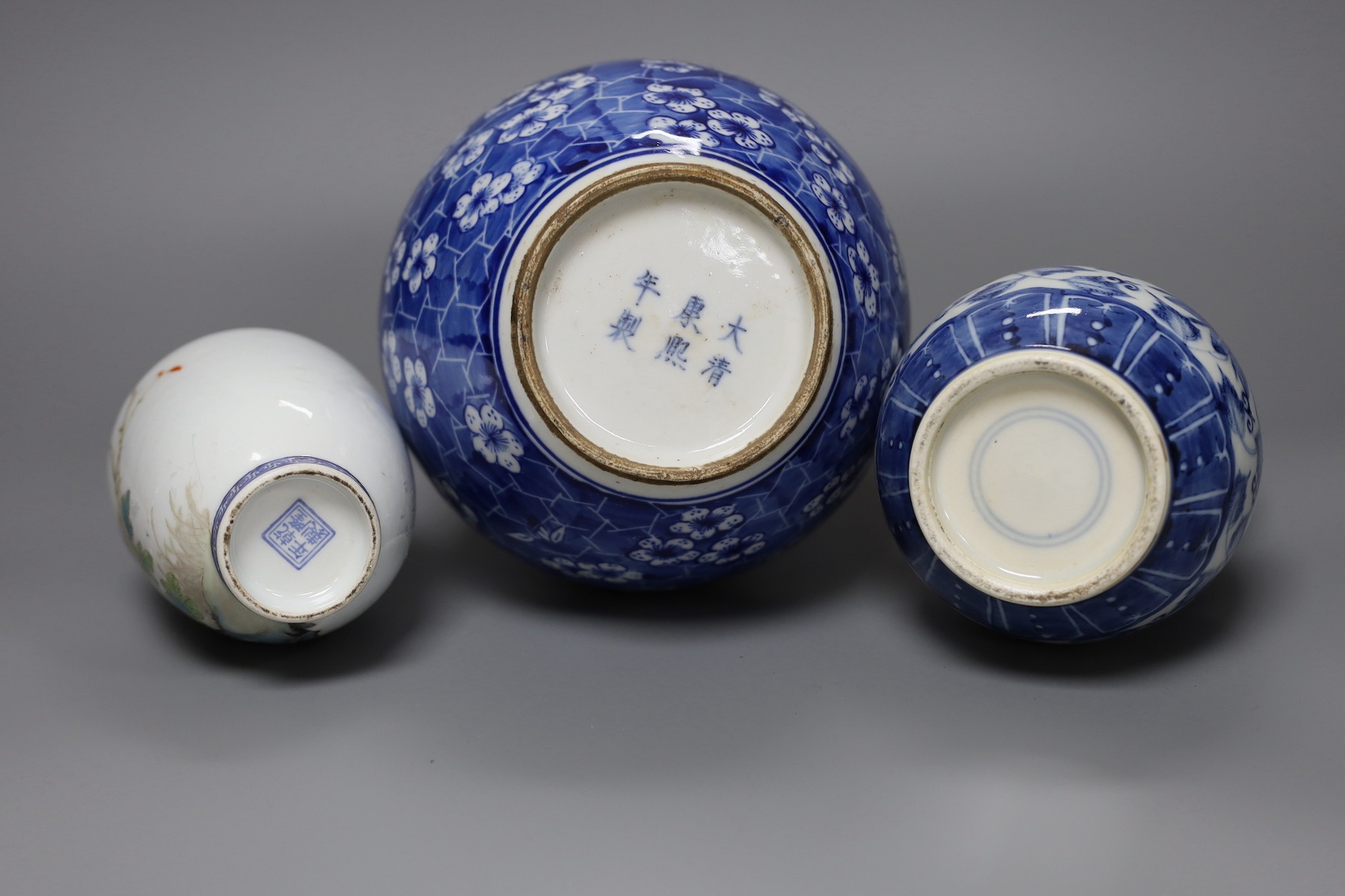 A Chinese blue and white bottle vase, a similar double gourd vase and a famille rose bottle vase a.f., tallest 26cm